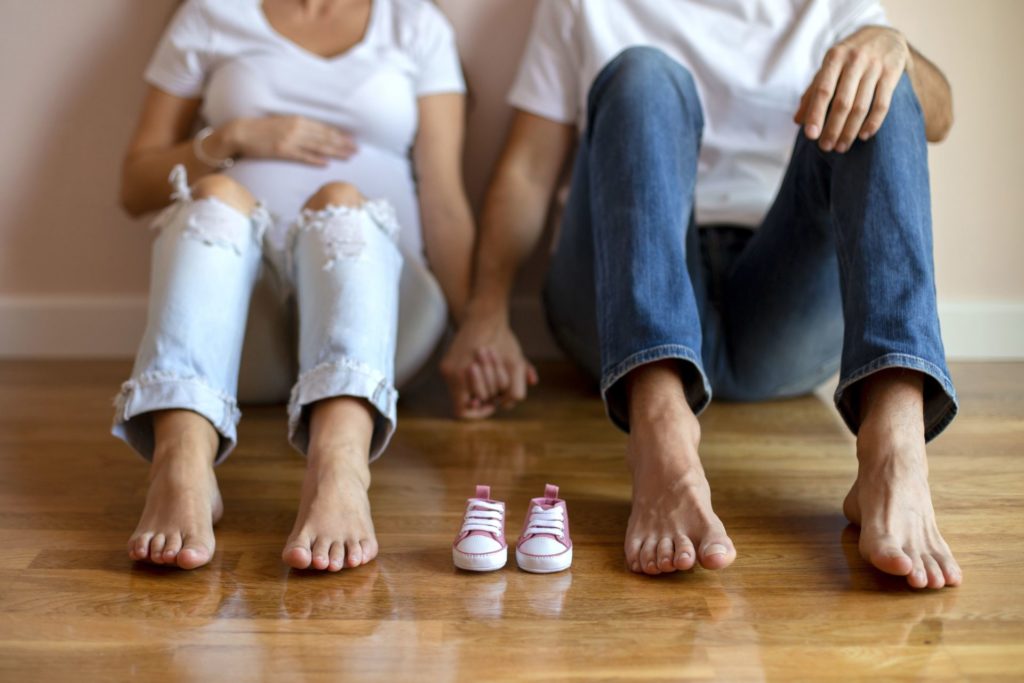 Expectant Parents with baby shoes