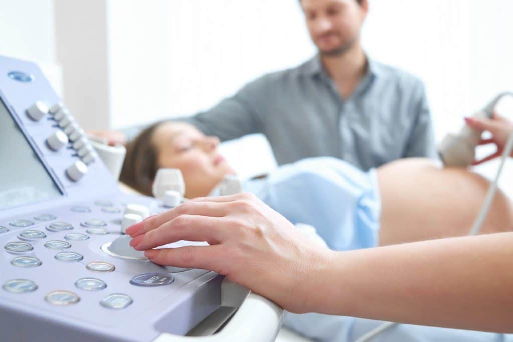 Pregnant woman getting ultrasound of baby